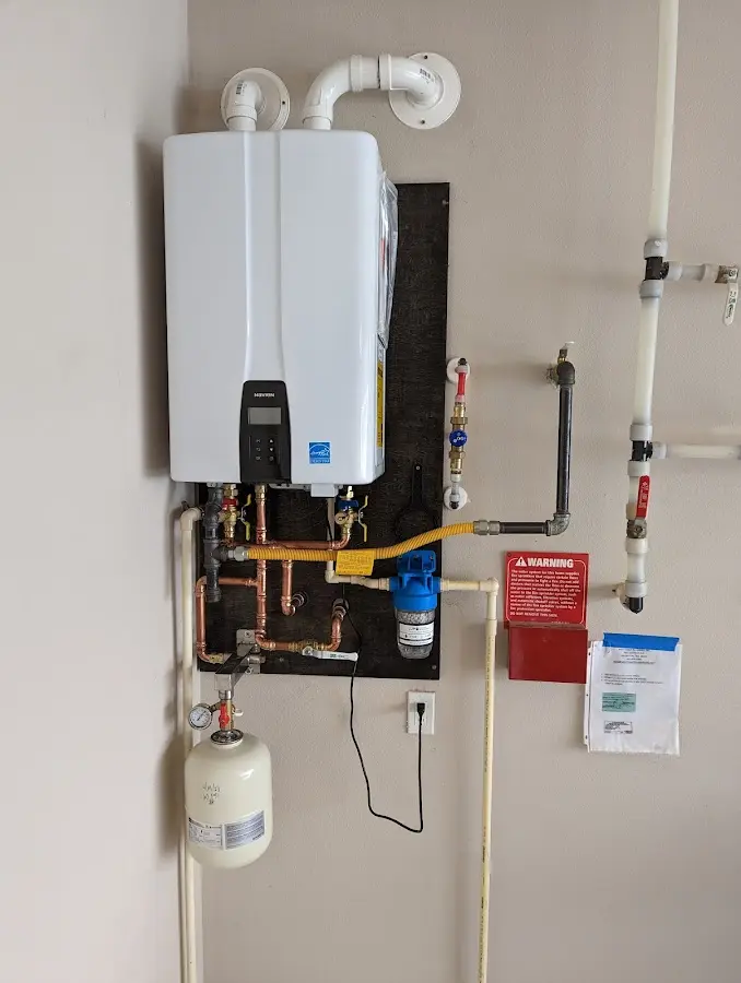 Professional plumber installing copper piping in a West Chester home